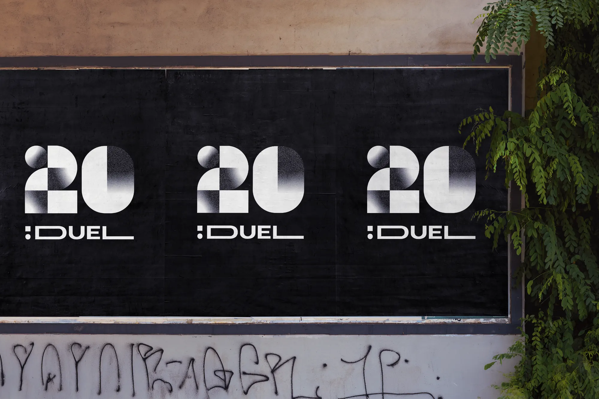 Three black posters with the 20 :DUEL logo pasted on a street wall